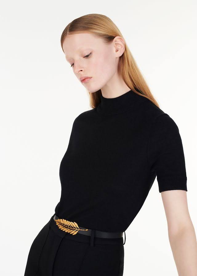 model wearing the gold fern leaf belt with ultra-fine cashmere mockneck in black by Adam Lippes