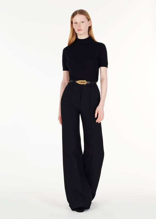 model wearing the gold fern leaf belt with the ultra-fine cashmere mockneck and the silk wool deeda pant in black