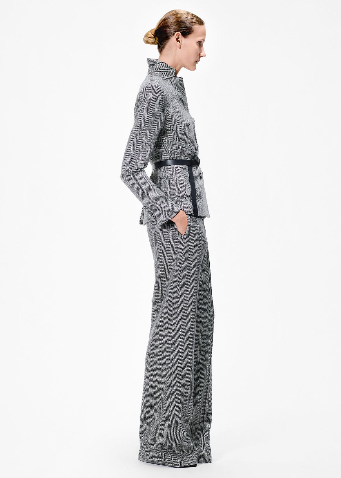 side view of model wearing the full leg trouser in wool herringbone with the spencer jacket 