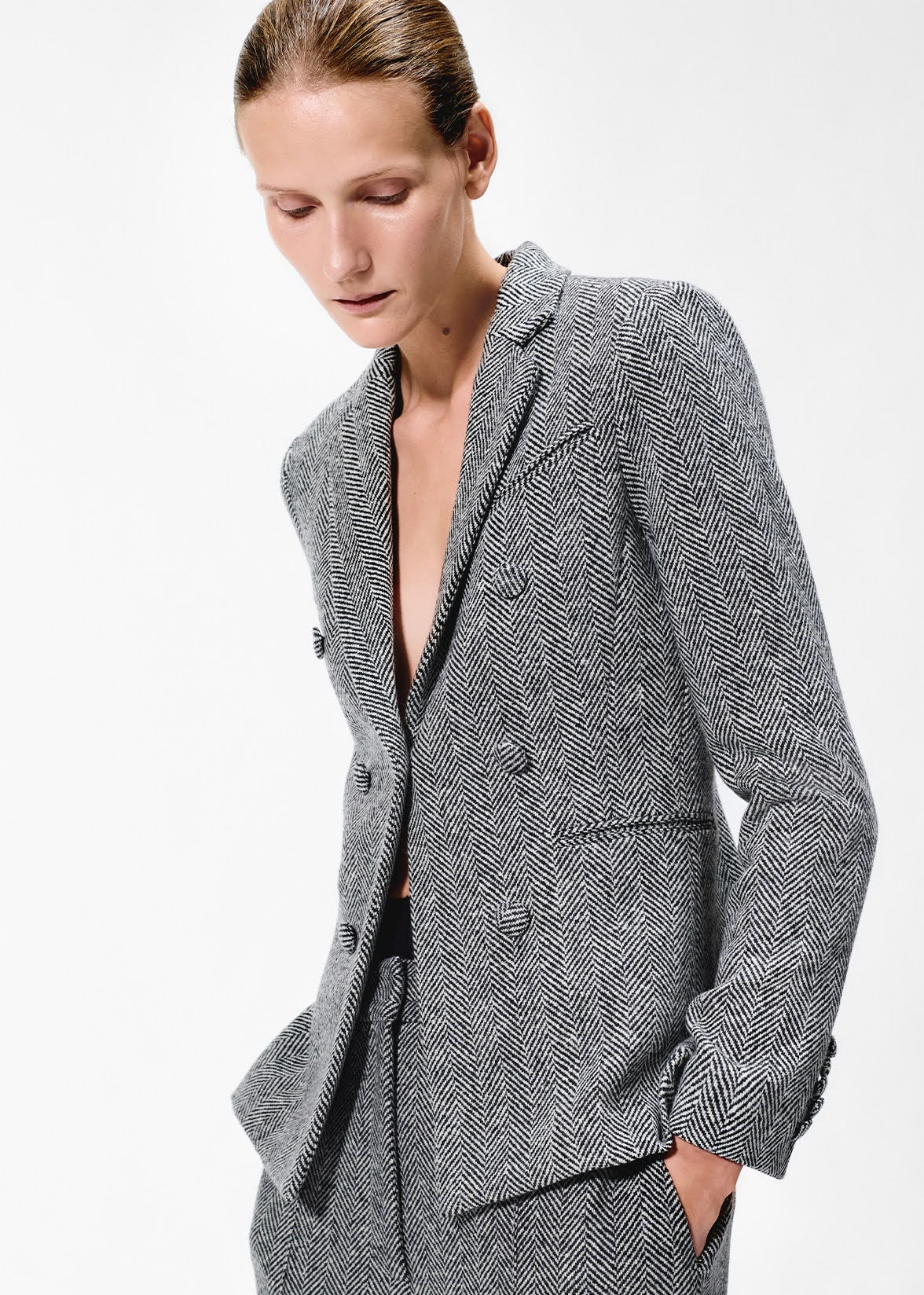 close up of model wearing the spencer jacket in wool herringbone