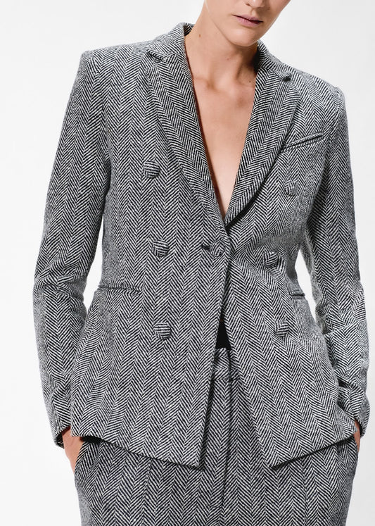 close up of model wearing the spencer jacket in wool herringbone