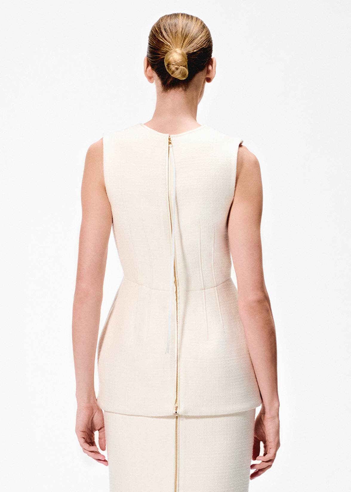 Back image of a model wearing an ivory sleeveless top