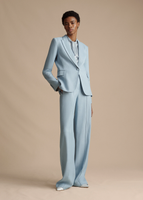 A full body image of a model wearing the Single Breasted Blazer in Stretch Canvas in Pale Blue, paired with the Trouser in Stretch Canvas and Draped Neck Shell in Silk Charmeuse