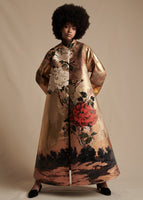 A model stands forward wearing a gold jacquard with rose print long coat.