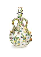 Photo of a large Minton bottle vase adorned in flowers, leaves, and insect motifs.