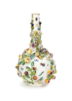 Photo of a large Minton bottle vase adorned in flowers, leaves, and insect motifs.