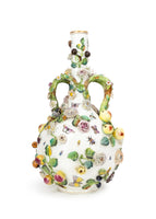 Photo of a large Minton bottle vase adorned in flowers, leaves, and insect motifs.