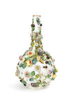 Photo of a large Minton bottle vase adorned in flowers, leaves, and insect motifs.