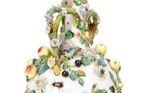 Photo of a large Minton bottle vase adorned in flowers, leaves, and insect motifs.