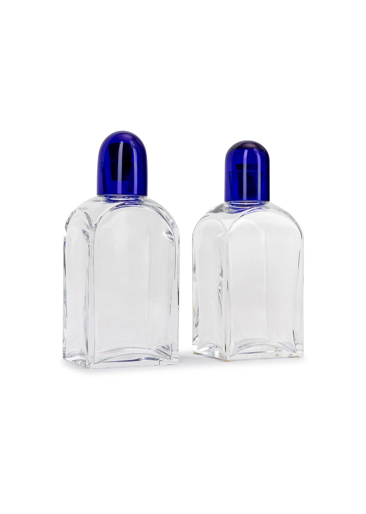 Photo of two Baccarat crystal decanters with blue caps.