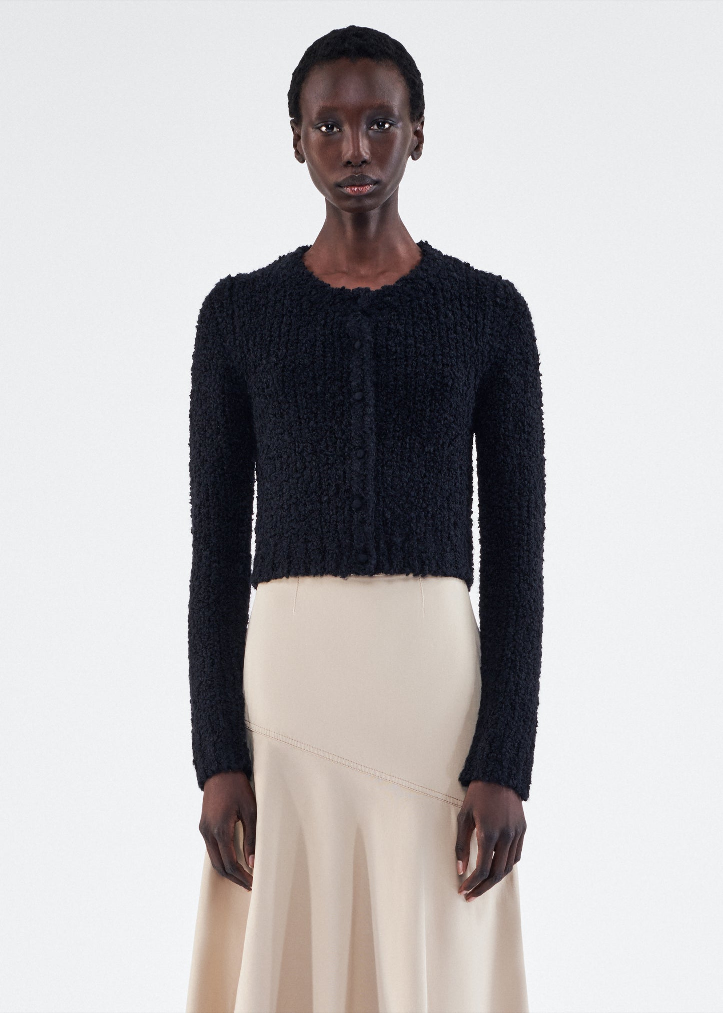 Front of model is wearing the Alice Cardigan in Mulberry Silk in Black