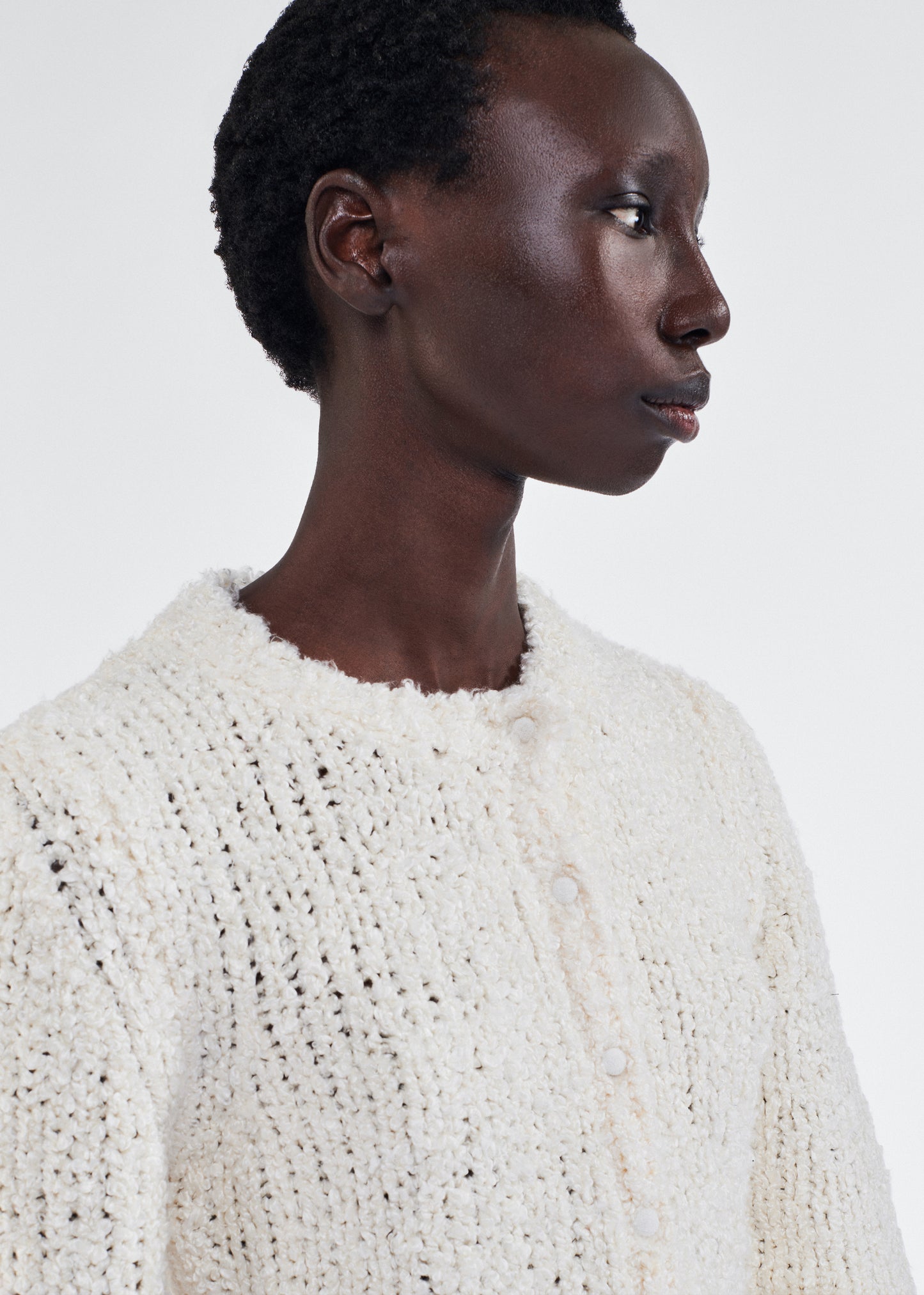 Close up of model wearing the Alice Cardigan in Mulberry Silk in Ivory