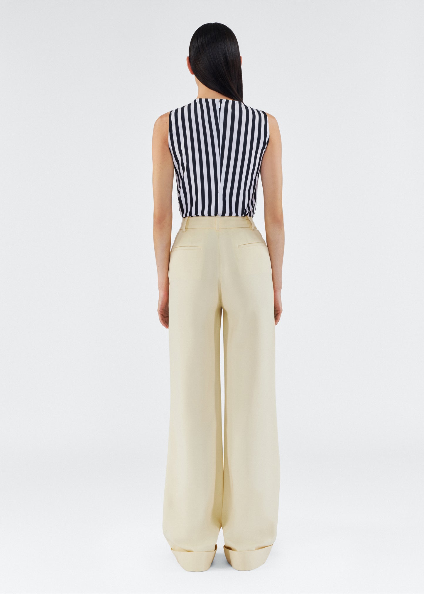 back view of model wearing the deeda pant by adam lippes in silk wool in beurre