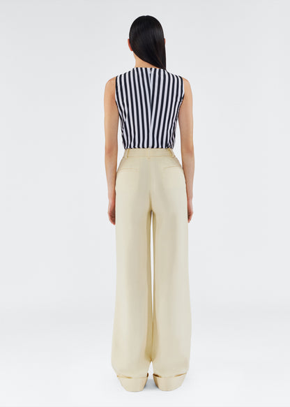 back view of model wearing the deeda pant by adam lippes in silk wool in beurre