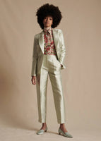 Model is wearing the Single Breasted Blazer in Silk Mikado in Pistachio. The model is also wearing the matching Harper Pant, Shirt with Thin Bow in Pistachio Multi and the Chantilly Lace Turtleneck in white.