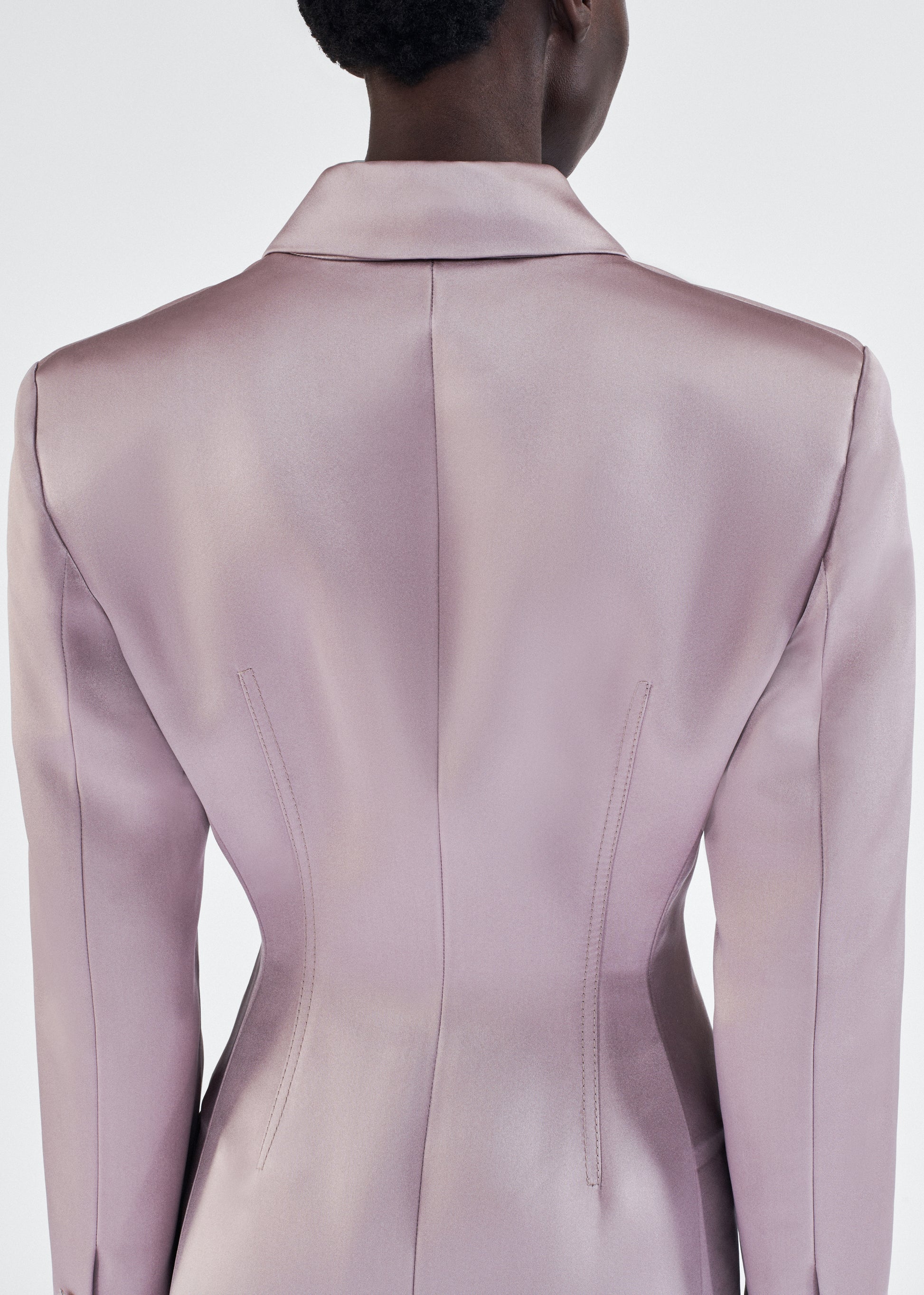 back detail of model wearing laurence coat by adam lippes in duchess satin in smokey amethyst