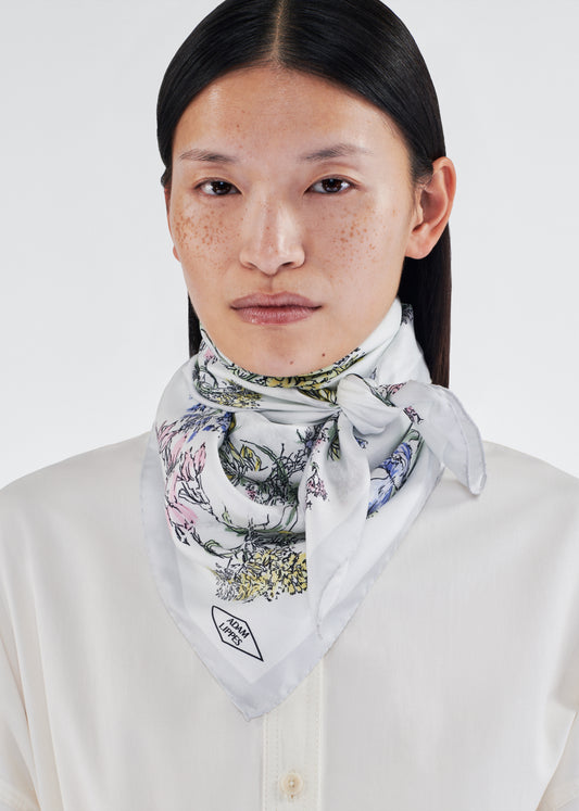 model wearing 34x34 scarf in printed silk twill by adam lippes in multi ivory floral