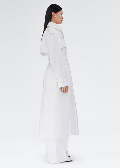 side view of the model wearing the monte trench by adam lippes in compact cotton poplin in white