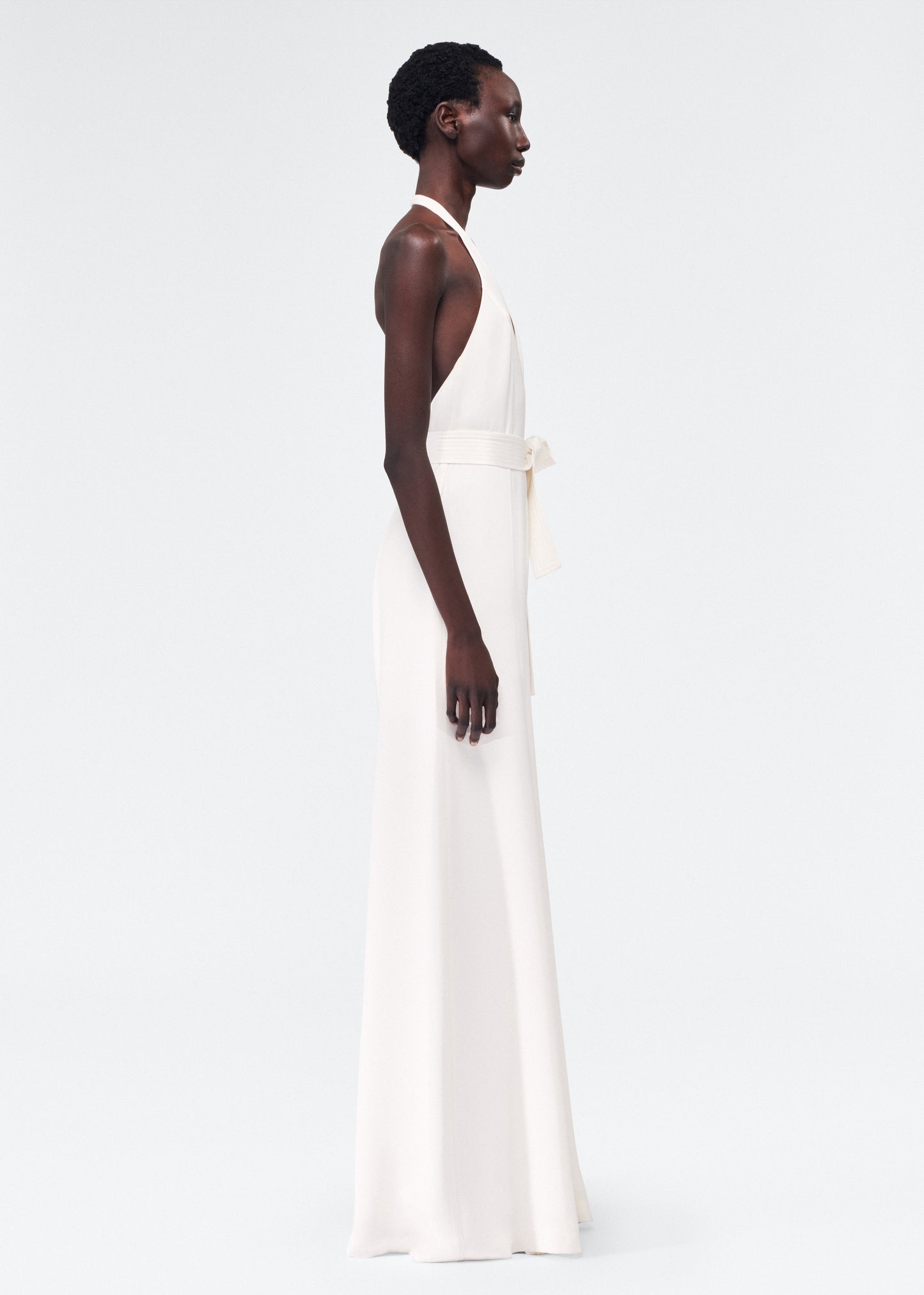 side view of model wearing the adam lippes gaia jumpsuit in silk crepe in ivory