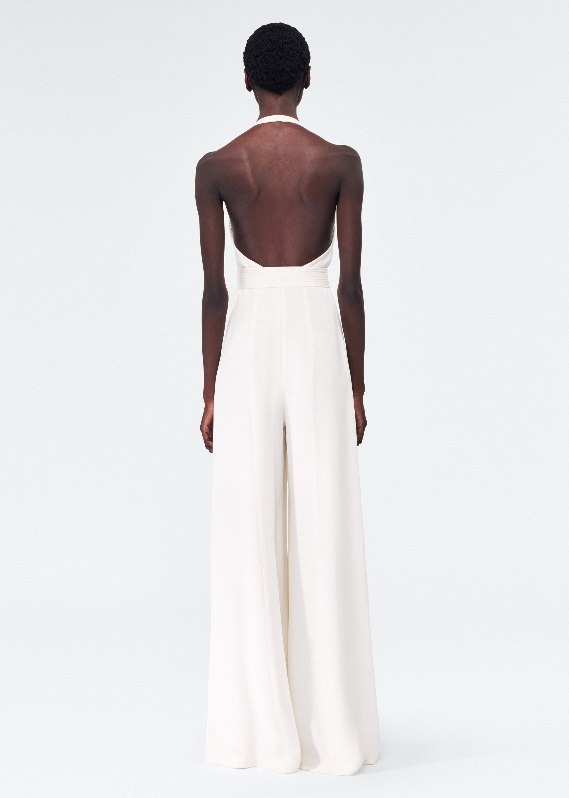 back view of model wearing the adam lippes gaia jumpsuit in silk crepe in ivory