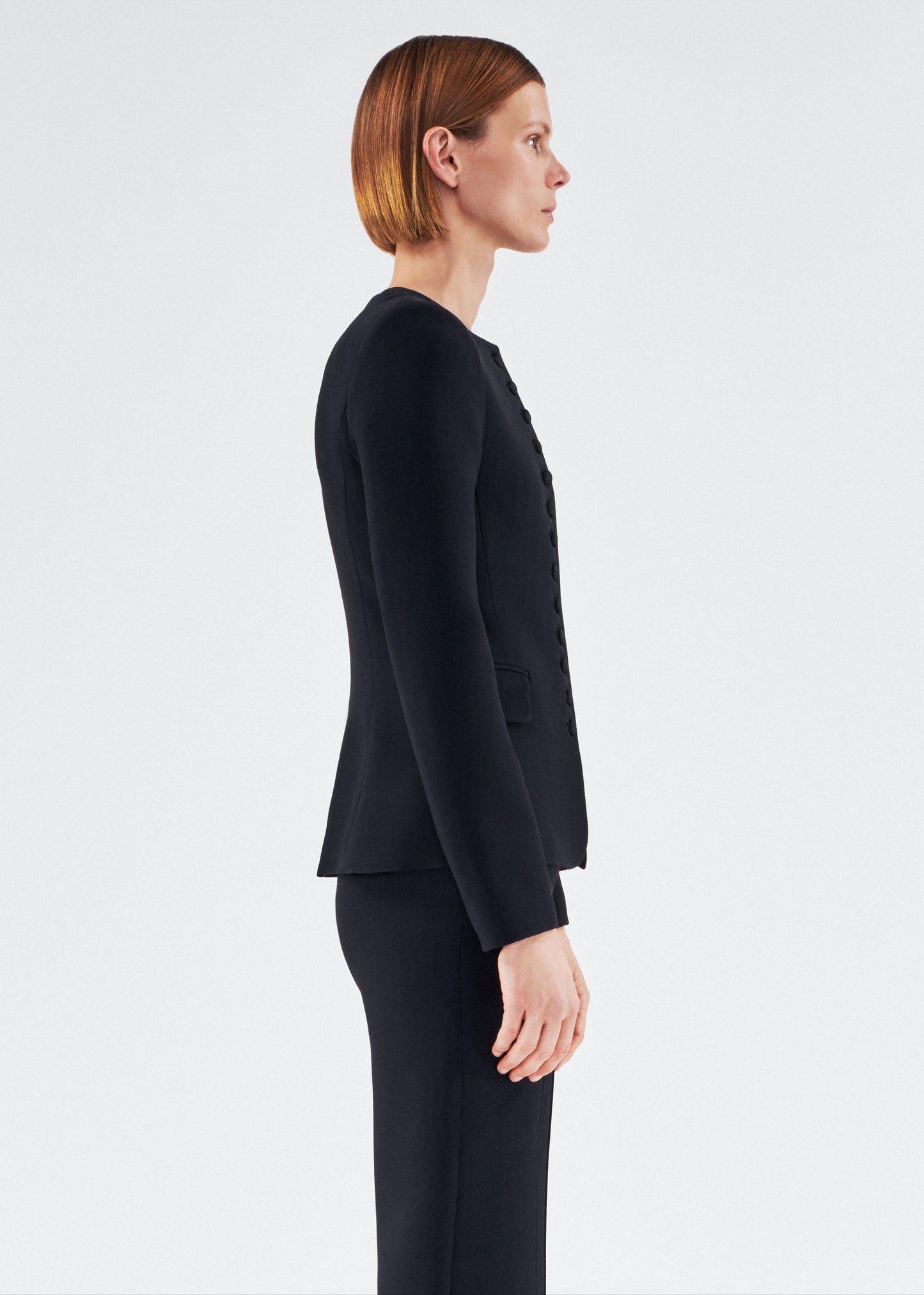 Side of model wearing the Marin Jacket in Silk Wool in Black