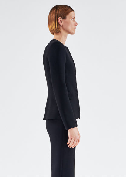 Side of model wearing the Marin Jacket in Silk Wool in Black