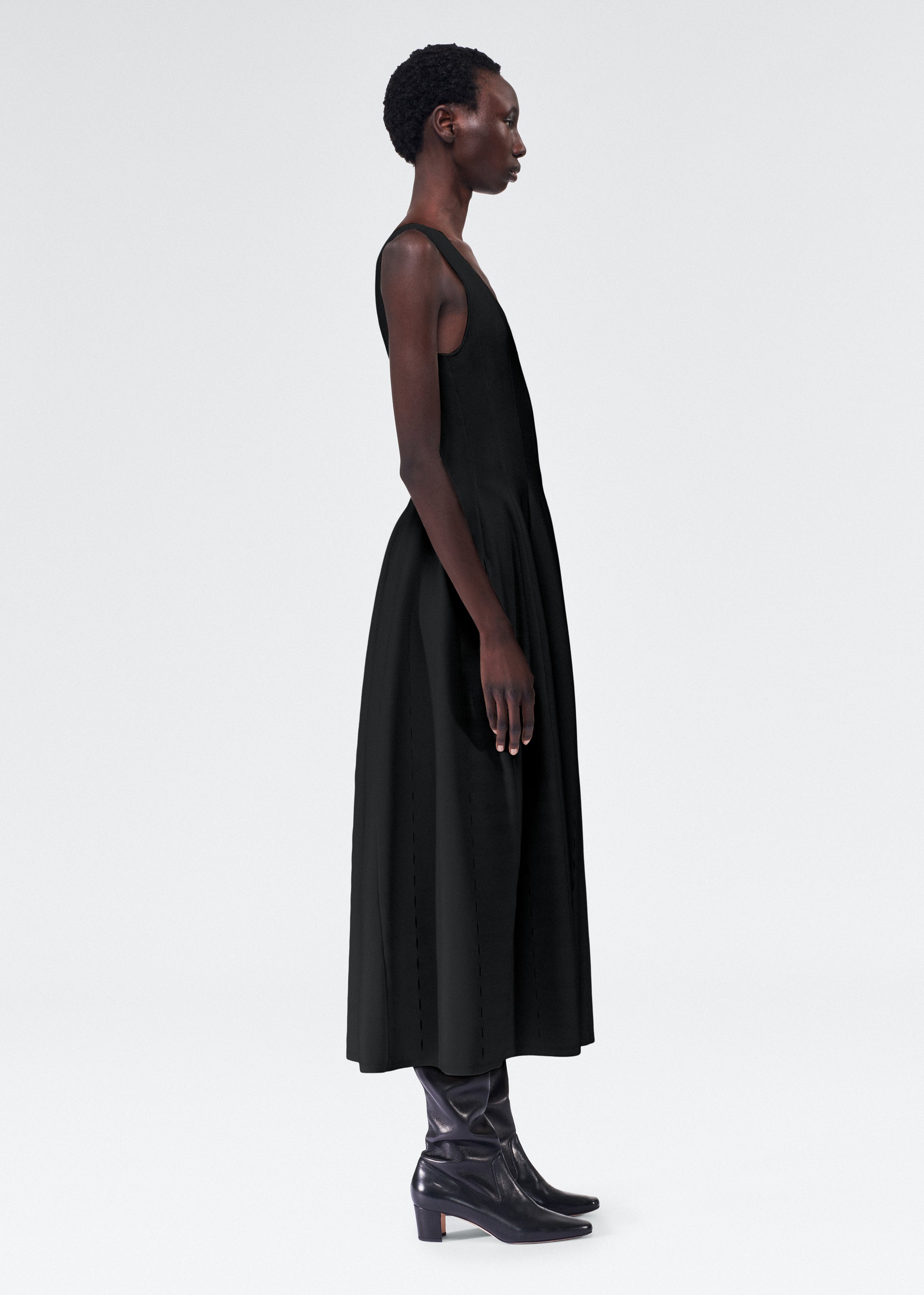 side view of model wearing the lucilla dress by adam lippes in luxe milano in black