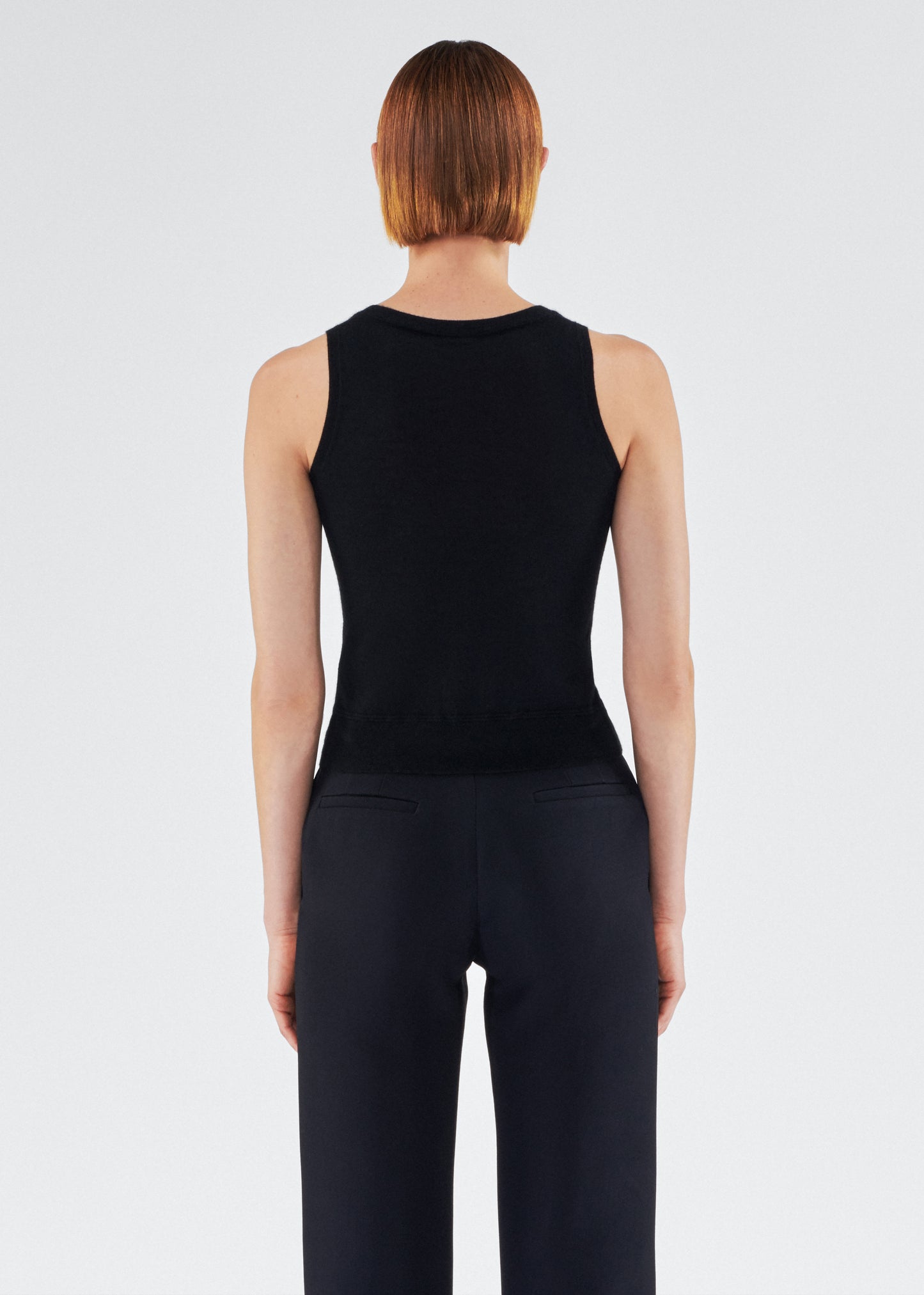 back view of model wearing the adam lippes shell in cashmere silk in black