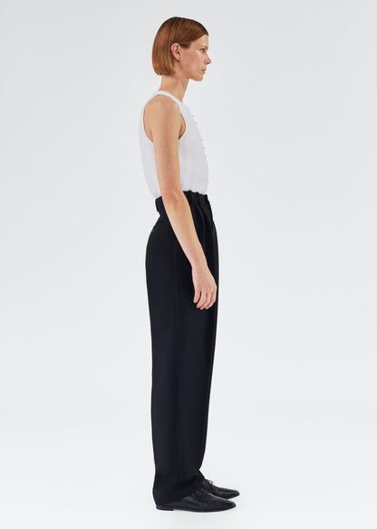 Side of model wearing the Nichols Pant in Silk Wool in Black