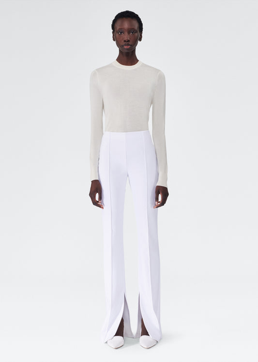 model wearing the adam lippes eva flare pant in bonded neoprene in white