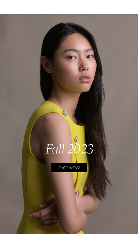 Fall 2023. Shop Now. A cropped image of a woman turned sideways wearing a yellow sleeveless dress.
