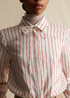 A close-up of a red and white striped shirt, collared with a hidden button placket. 