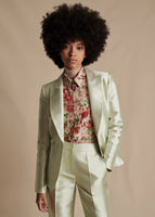Close up of the model wearing the Single Breasted Blazer in Silk Mikado in Pistachio. The model is also wearing the matching Harper Pant, Shirt with Thin Bow in Pistachio Multi and the Chantilly Lace Turtleneck in white.