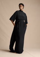 Model wearing the Cape Back Gown in Silk Crepe in Black.