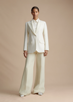 A model wearing the Tux Jacket in Radzimir Wool in White, styled with the Deeda Pant in Silk Wool.