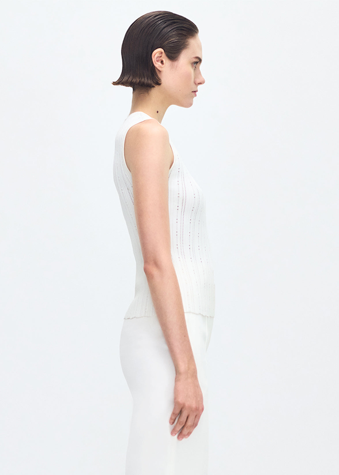 side profile of model wearing the brynn top in compact jacquard ivory