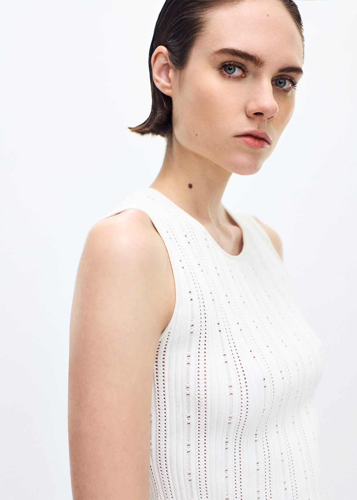 close up of model wearing the brynn top in compact jacquard ivory