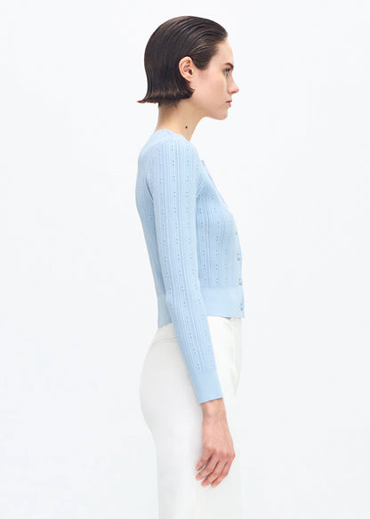 side profile of model wearing the FAYE CARDIGAN IN COMPACT JACQUARD in MIST