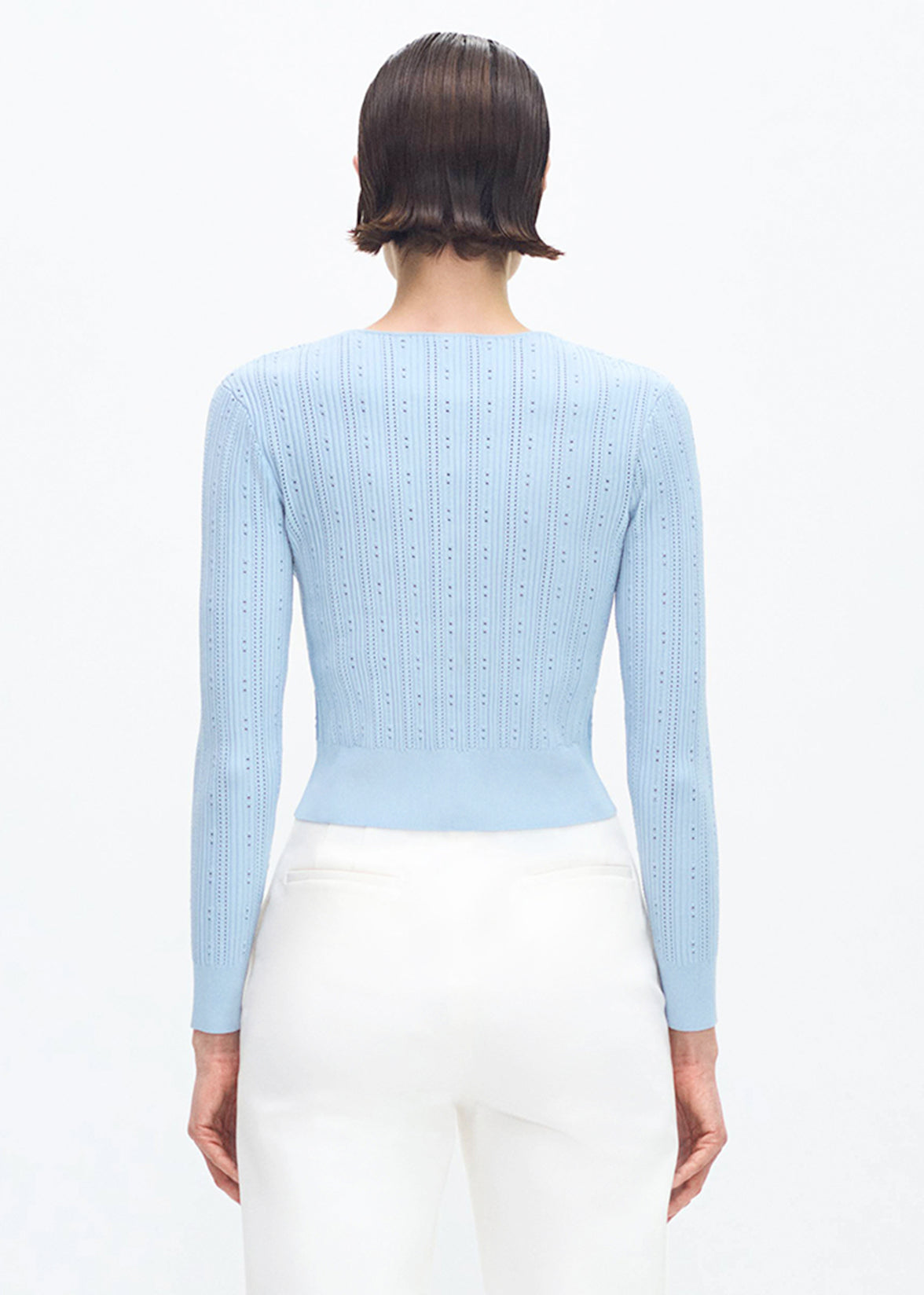 back profile of model wearing the FAYE CARDIGAN IN COMPACT JACQUARD in MIST