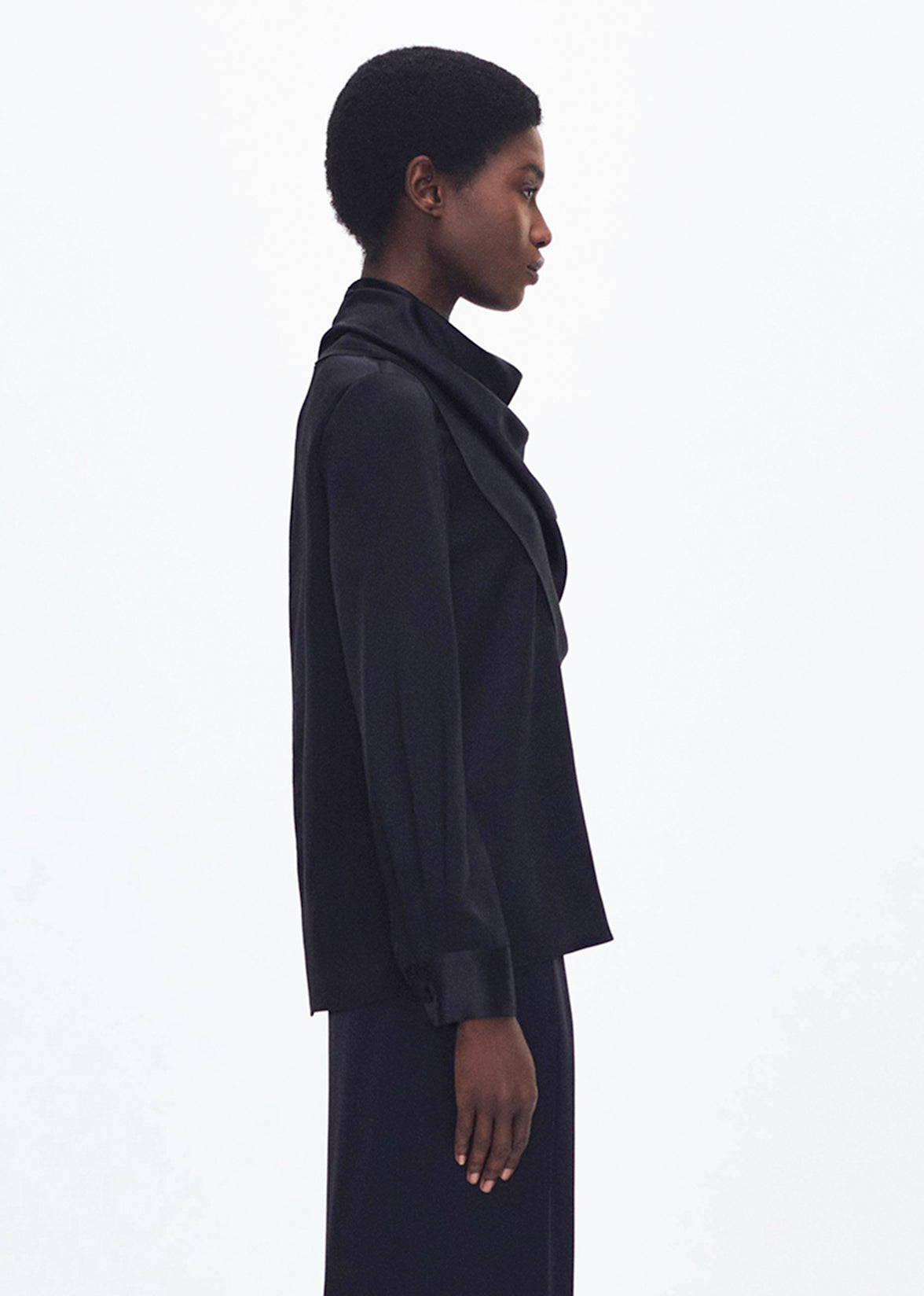 side profile of model wearing the bandera blouse in silk in black