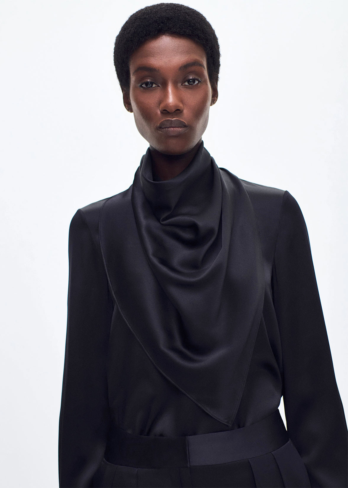 close up of model wearing the bandera blouse in silk in black