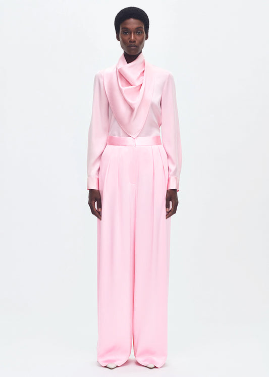 Front-facing model wearing the nils pant in pink silk charmeuse