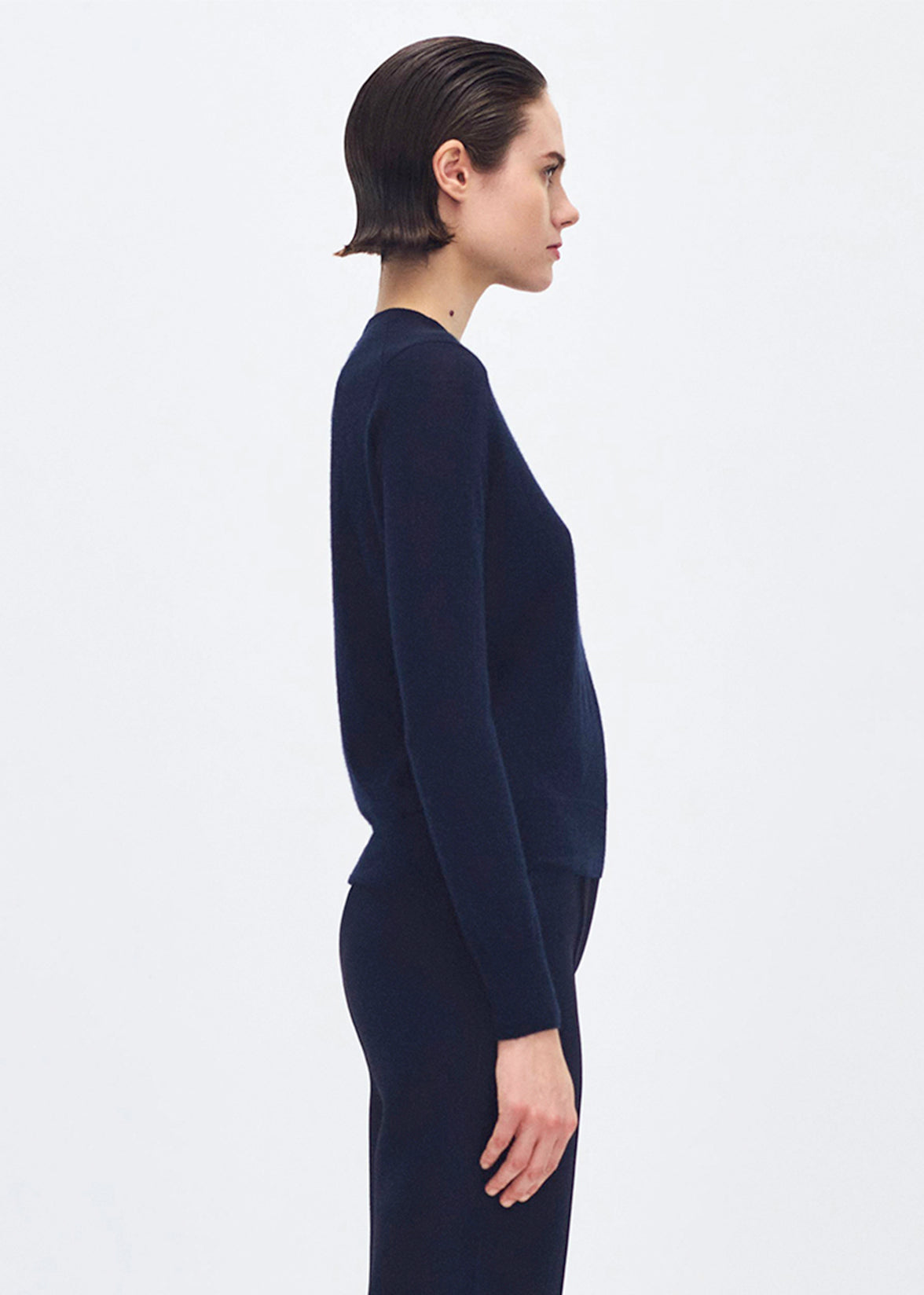 side profile of model wearing the didion knit in navy