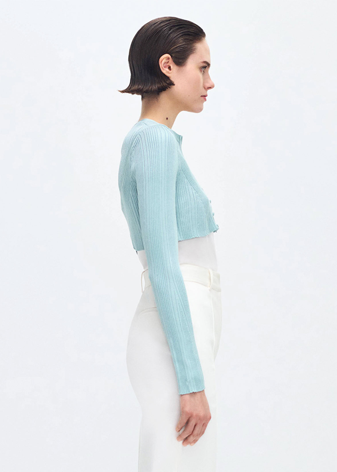 side profile of model wearing the Glynis Cardigan in Mist