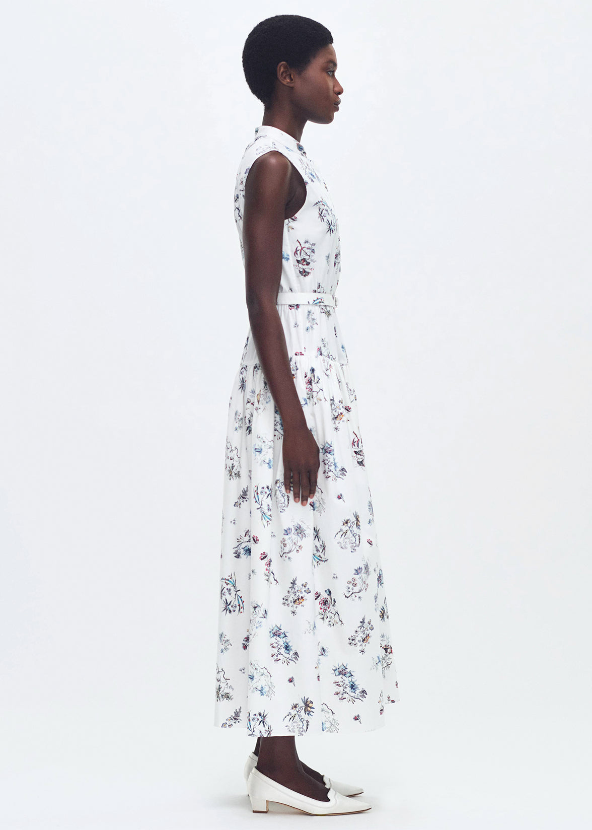 side profile of model wearing the arden dress in printed poplin in ivory floral