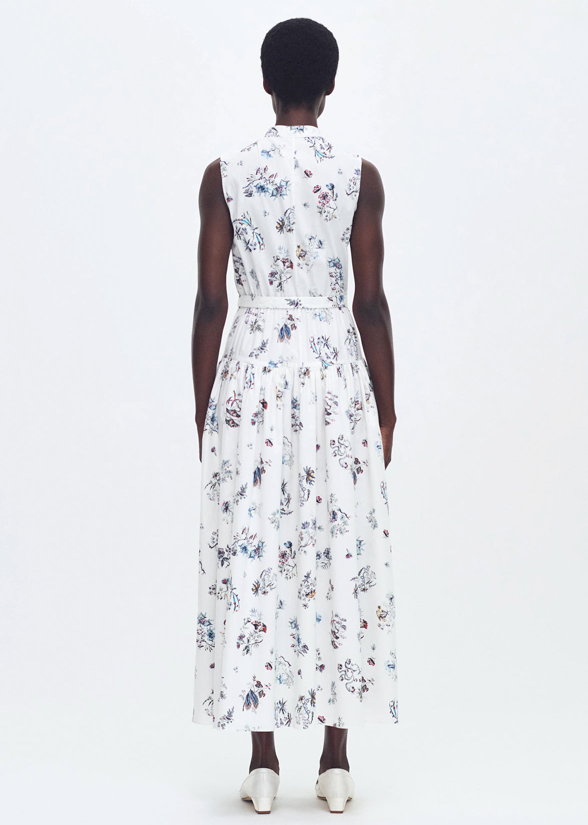 back profile of model wearing the arden dress in printed poplin in ivory floral