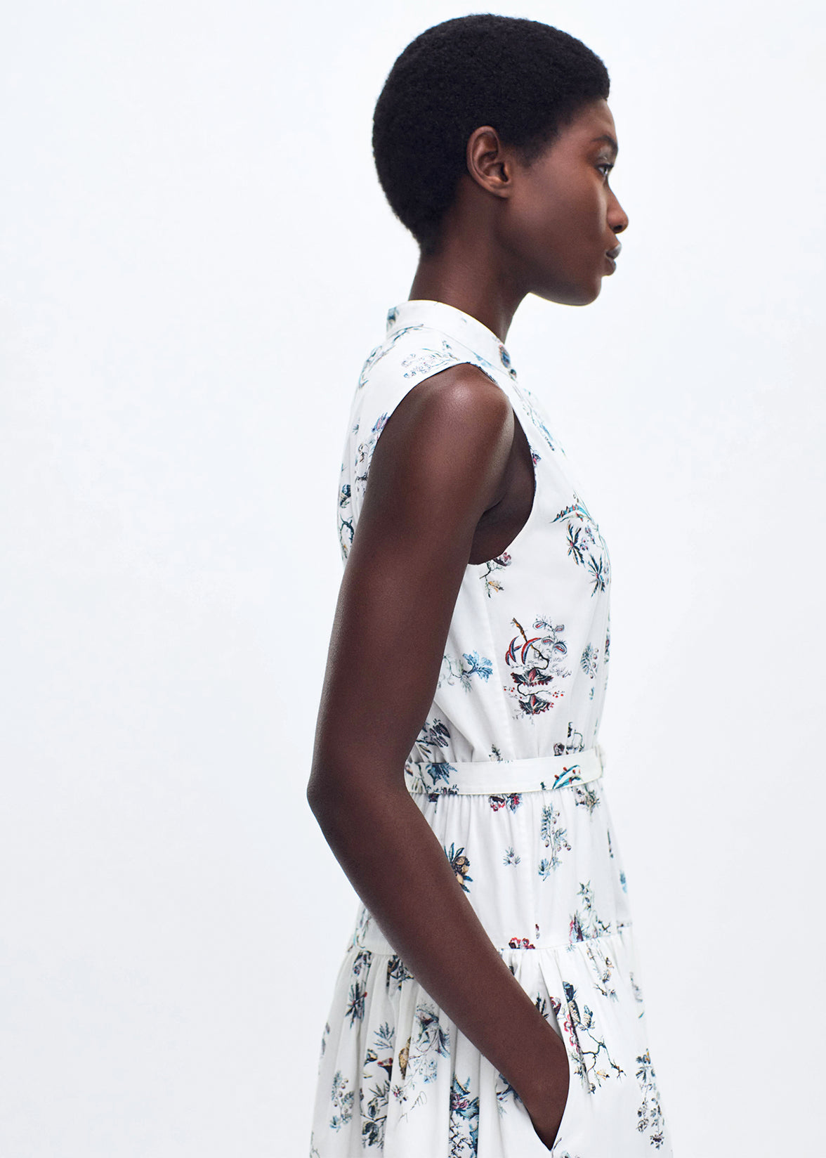 close up side profile of model wearing the arden dress in printed poplin in ivory floral