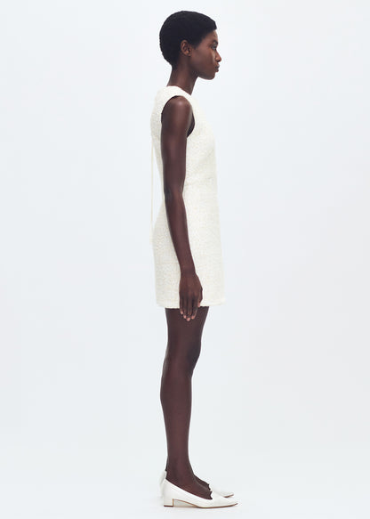 side full body profile of model wearing the tati dress in tweed in ivory