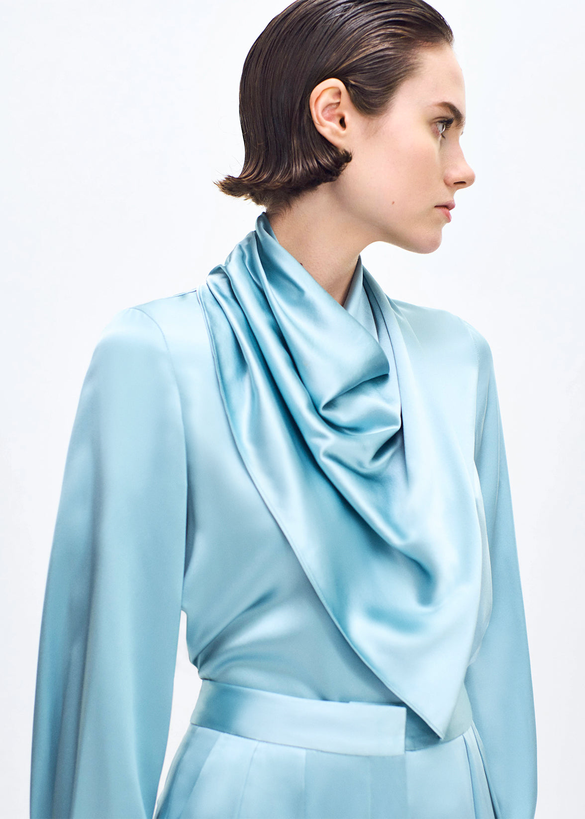 close up of model wearing the bandera blouse in silk in mist