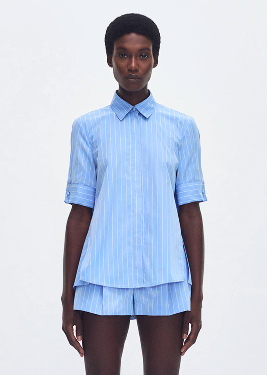 model wearing the trapeze shirt in stripe poplin in pale blue 